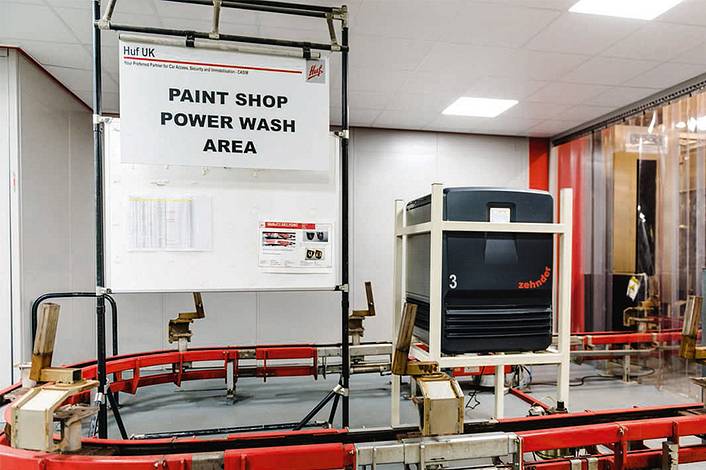 Industrial air purification unit stands in the centre of a conveyor belt.