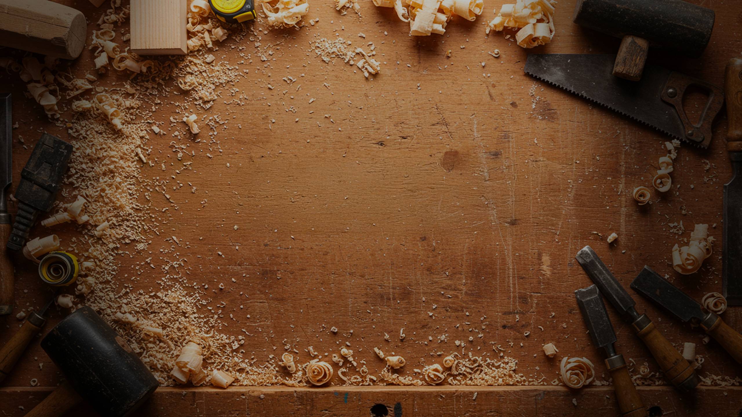 A workbench full of wood chips and tools.