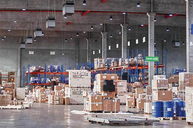 Large logistics hall with industrial air purifiers.