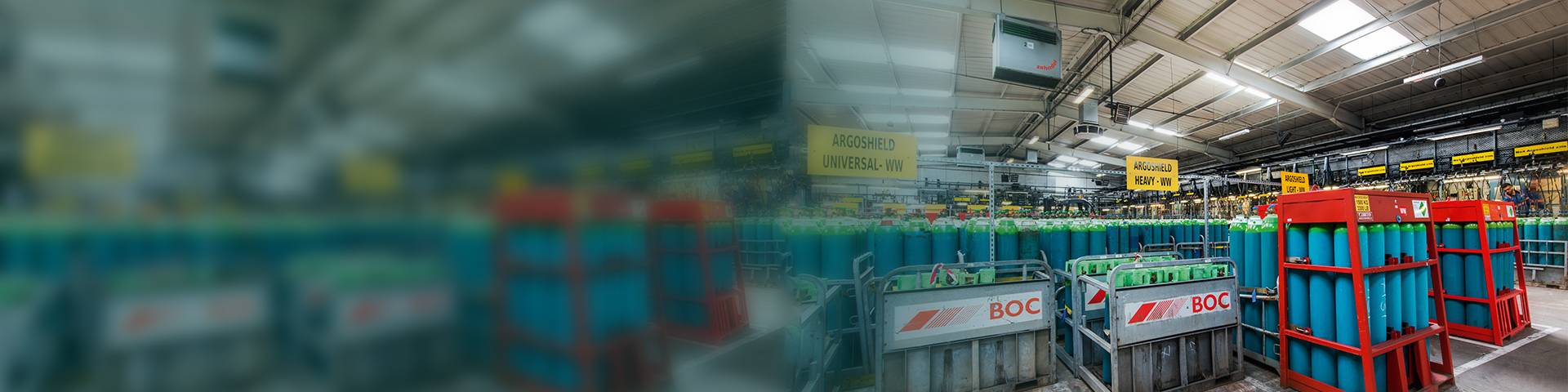 Industrial air purifier in an industrial hall with stored gas cylinders.