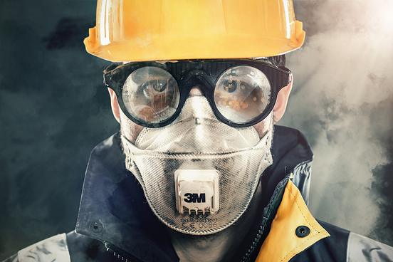 Construction worker with mask protecting himself from Silica dust
