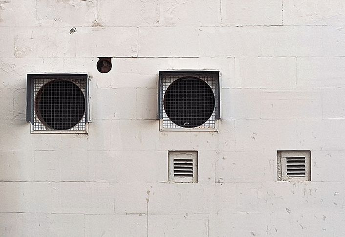 Industrial ventilation grille on concrete wall with vents