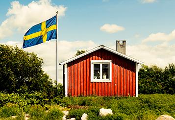 Small red house on the lake in Sweden symbolising the history and roots of Zehnder Clean Air Solutions