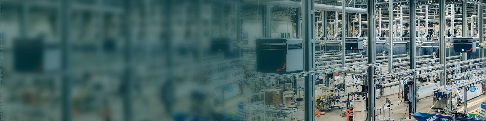 Modern industrial hall with automated production facilities and industrial air filtration systems.