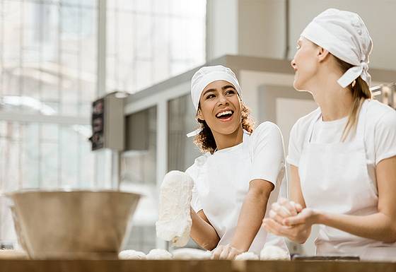 Two bakers producing dough in a wholesale bakery