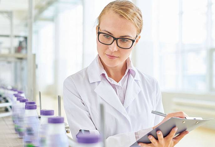 Food inspector checking dairies for food hygiene compliance