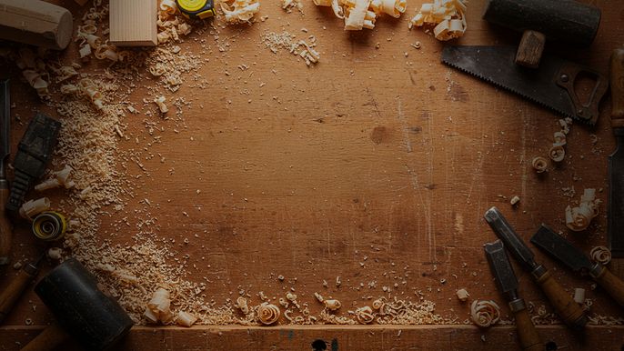 A workbench full of wood chips and tools.