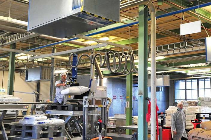 Workers in hygienic clothing processing raw materials.