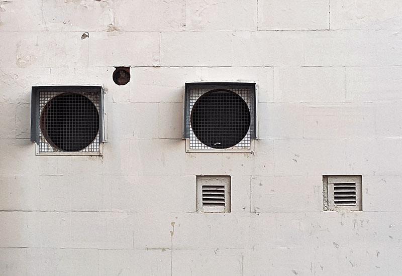Industrial ventilation grille on concrete wall with vents