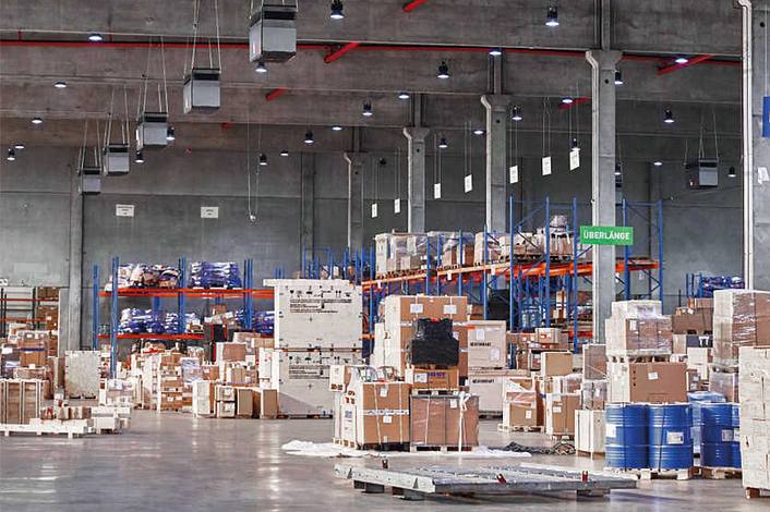 Large logistics hall with industrial air purifiers.