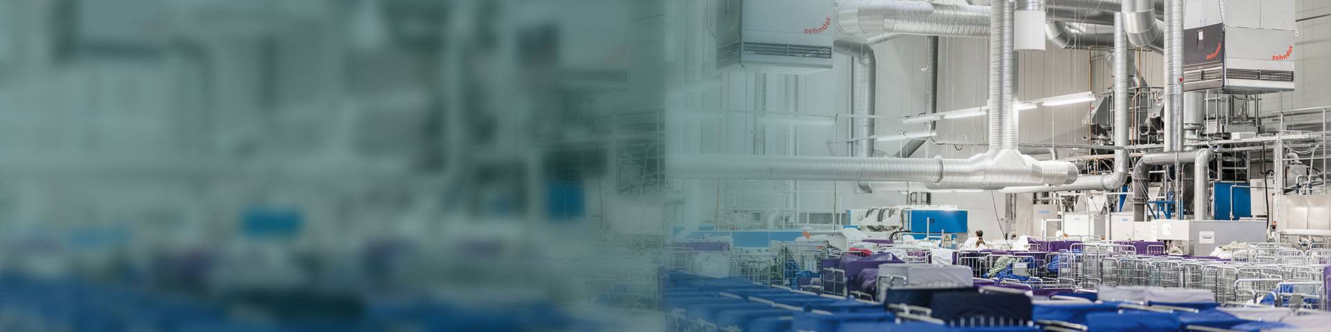 Industrial air purification systems hanging above production facilities in a textile factory.